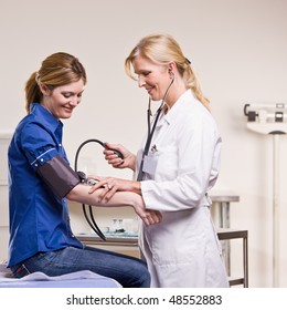 Doctor Checking Woman Blood Pressure