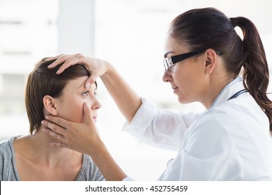 Doctor Checking Woman Eye At Clinic