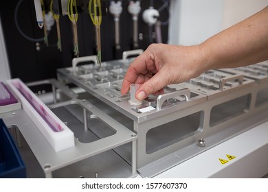 the doctor checks blood tests in test tubes on a centrifuge using a computer for the presence of diseases