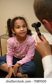 Doctor Checks Young Child In An Exam Room