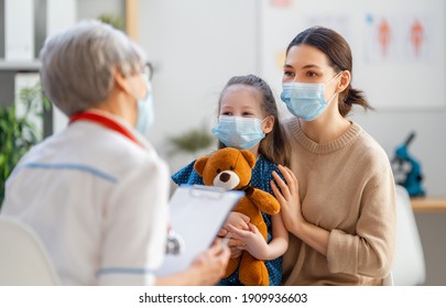 Doctor, Child And Mother Wearing Facemasks During Coronavirus And Flu Outbreak. Virus Protection. COVID-2019. Taking On Masks.