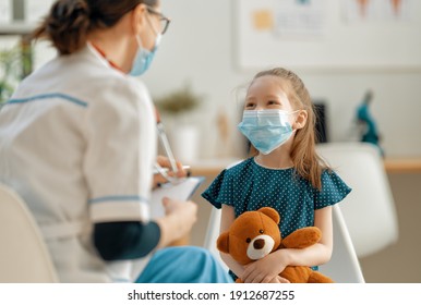 Doctor And Child Wearing Facemasks During Coronavirus And Flu Outbreak. Virus Protection. COVID-2019. Taking On Masks.