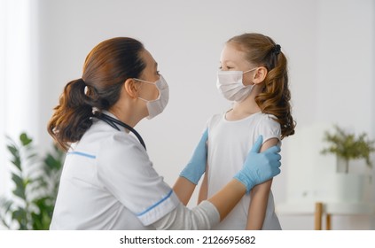 Doctor And Child Wearing Facemasks During Coronavirus And Flu Outbreak. Virus Protection. COVID-2019. Taking On Masks.