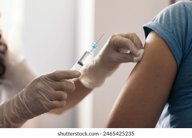 doctor cleaning arm with cotton before vaccination - Powered by Shutterstock