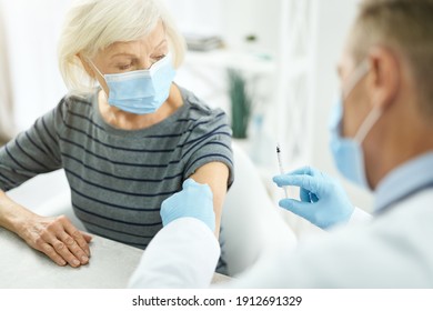 Doctor Cleaning Patient Arm With Alcohol Swab Before Injection