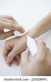 Doctor Cleaning Wound On Patient's Hand, Cropped View