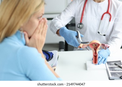 Doctor climbing fallopian tube with scissors onto artificial models on uterus and ovaries in clinic. Infertility obstruction of fallopian tubes concept - Shutterstock ID 2149744047