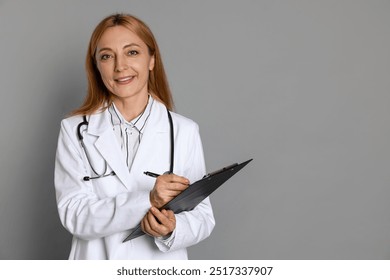 Doctor with clipboard writing notes on gray background, space for text - Powered by Shutterstock