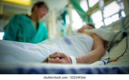 Doctor comforting a patient in an intensive care unit in a hospital - Shutterstock ID 532149166
