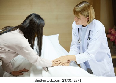 doctor comforting or reassuring family member patient on bed in hospital - Shutterstock ID 2370142871