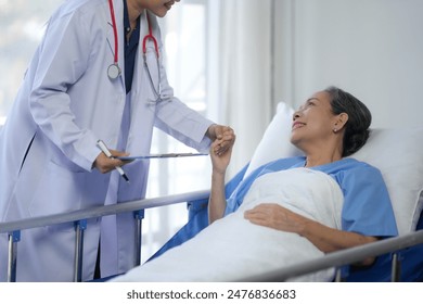 Doctor comforting a senior patient in a hospital bed, promoting healthcare and support in a medical setting. - Powered by Shutterstock