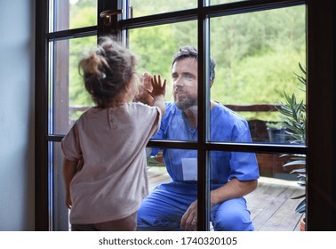 Doctor Coming To See Family In Isolation, Window Glass Separating Them.