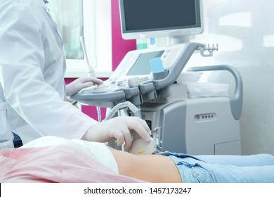 Doctor conducting ultrasound examination of internal organs in clinic, closeup