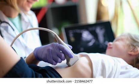 Doctor Conducting Ultrasound Examination Of Internal Organs Of Child In Clinic. Diagnosis And Treatment Of Diseases Of Liver And Biliary Tract In Children Concept