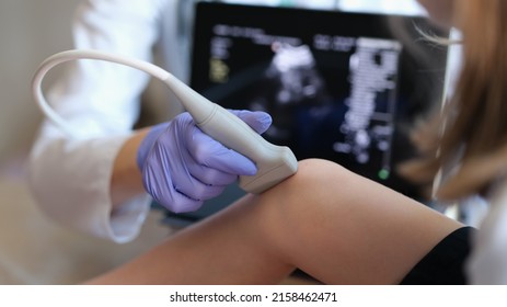 Doctor conducting ultrasound examination of knee joint in child closeup. Diagnosis of bone diseases in children concept - Shutterstock ID 2158462471