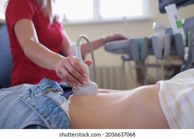 Doctor conducting ultrasound examination of pelvic organs to patient in clinic closeup