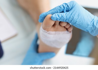 Doctor conducts medical examination of foot with patch. Pain attacks concept - Shutterstock ID 2144920425