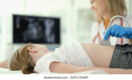 Doctor conducts ultrasound examination of internal organs of child in clinic - Powered by Shutterstock