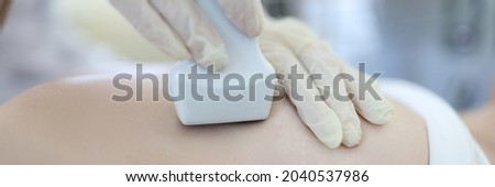 Doctor conducts ultrasound examination of mammary glands of woman