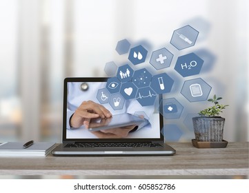 Doctor, Consultant Using Digital Tablet With Health Icons Flow From Home Or Office Laptop Computer On Virtual Screen, Medical Technology, E Health Or Online Service, Telemedicine Concept