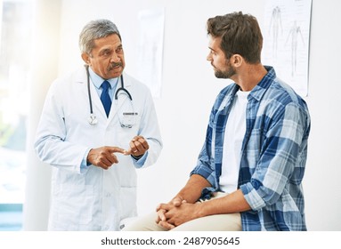 Doctor, consultation and man for healthcare with help, conversation and diagnosis in clinic. Hospital, patient and communication for medicine and sick person, mature professional and medical results - Powered by Shutterstock