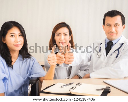 Doctor In Consultation With  Patient.The patient feels hopeful, happy and safe.doctor and patient holding red heart and Thumb up.