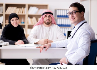 Doctor Consulting Arab Family At Hospital