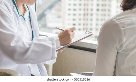 Doctor Consulting And Examining Woman Patient's Health In Medical Clinic Or Hospital