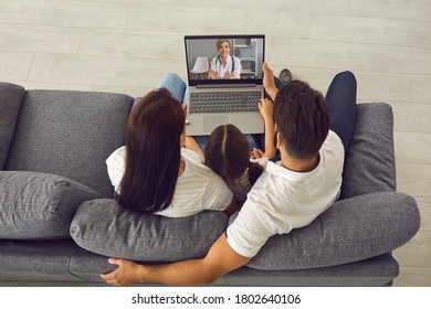 Doctor consulting family online with laptop video call