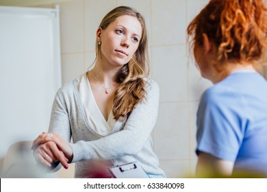 Doctor consulting her female patient. Patient and doctor sitting in office. Diagnostic, prevention of women diseases, healthcare, medical service, consultation or education, healthy lifestyle concept - Shutterstock ID 633840098