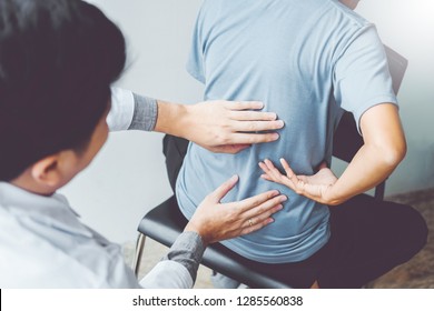 Doctor consulting with patient Back problems Physical therapy concept - Powered by Shutterstock