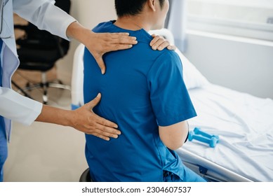 Doctor consulting with patient Back problems Physical on the bed in clinic therapy concept 
