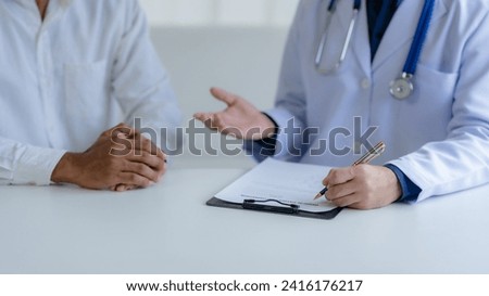 Doctor Consulting with Patient in Clinic.