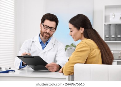 Doctor consulting patient during appointment in clinic