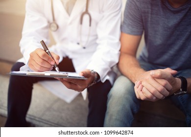 Doctor Consulting Patient While Sitting, Patient Sitting At Capital City,  Healthcare, Medical Service, Consultation Or Education, Healthy Lifestyle Concept,Doctor And Patient Are Discussing Something