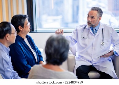 Doctor consulting senior group old patient. doctor talking to a patient group in the office - Powered by Shutterstock