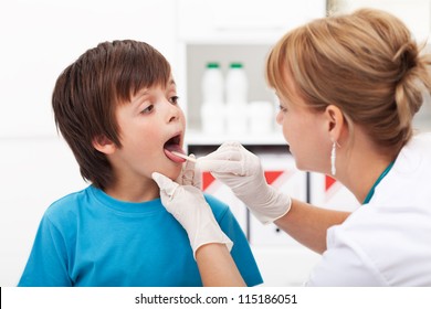 Doctor Consulting A Young Boy - Sore Throat Concept