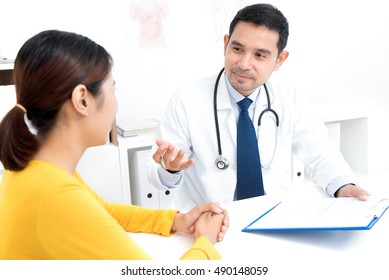 Doctor Consulting With Young Woman As A Patient