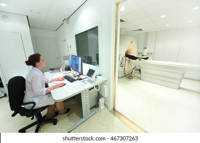 Doctor In Control Room, And Magnetic Resonance Imaging Machine With Patient