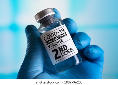doctor with Coronavirus vaccine bottle with the name of the Second vaccine on the label. COVID-19 Vaccine Vial for vaccination tagged with 2nd dose - Shutterstock ID 1989796208