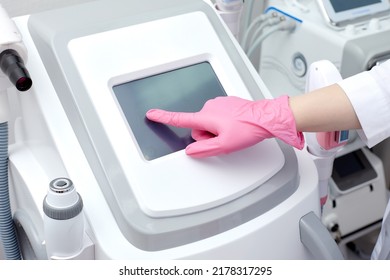 Doctor Cosmetologist Adjusts The Device For Photorejuvenation Using The Touchscreen