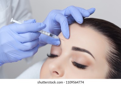 The doctor cosmetologist makes the Rejuvenating facial injections procedure for tightening and smoothing wrinkles on the face skin of a beautiful, young woman in a beauty salon.Cosmetology skin care. - Shutterstock ID 1109564774