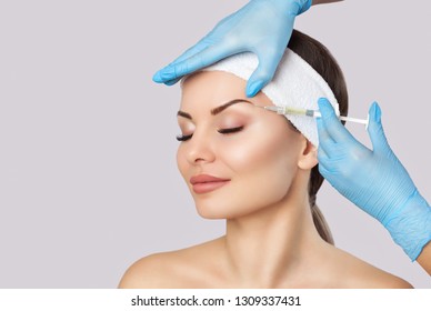 The doctor cosmetologist makes the Rejuvenating facial injections procedure for tightening and smoothing wrinkles on the face skin of a beautiful, young woman in a beauty salon.Cosmetology skin care. - Shutterstock ID 1309337431