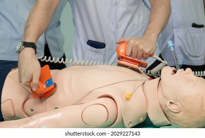 doctor defibrillate dummy Exam doctors but emergency resuscitation. CPR Training in emergency refresher training to assist of physician.concept of saving lives.