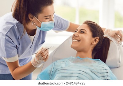 Doctor dentist or nurse conducting a medical checkup of a patient in a clinic, using a dental instrument. Oral care examination improving dental health, providing quality dentistry service. - Powered by Shutterstock