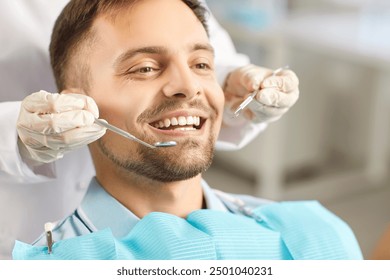 Doctor dentist performing a dental exam on a man patient during a clinic visit, using an instrument for a detailed checkup. The importance of oral healthcare and dentistry in everyday life. - Powered by Shutterstock