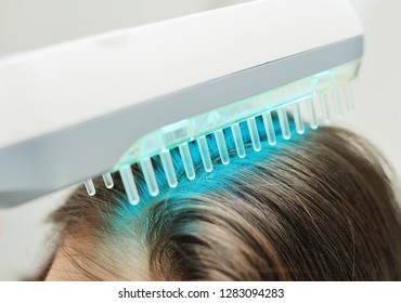 Doctor Dermatologist Performs The Procedure Of Ultraviolet Comb To Cure Psoriasis. Phototherapy, Light Therapy