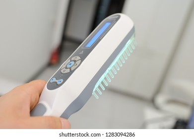 Doctor Dermatologist Performs The Procedure Of Ultraviolet Comb To Cure Psoriasis. Phototherapy, Light Therapy