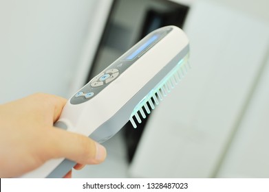 Doctor Dermatologist Performs The Procedure Of Ultraviolet Comb To Cure Psoriasis. Phototherapy, Light Therapy