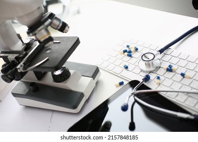 Doctor Desk With Mess And Chaos On Surface, Stethoscope Tool, Scattered Pills On Keyboard